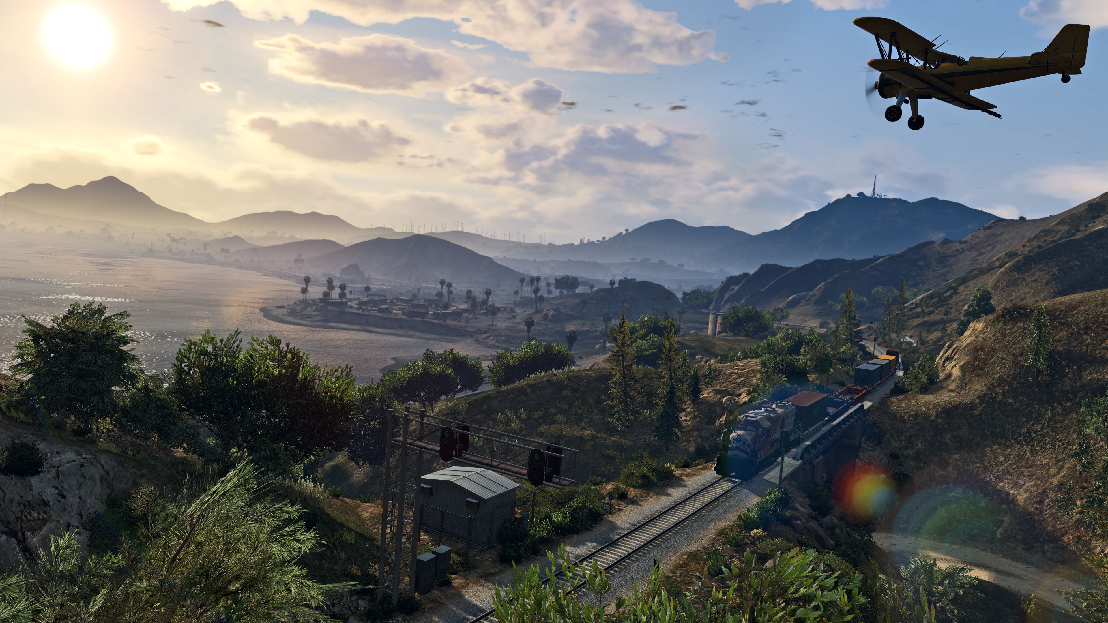 Screenshot from video game Grand Theft Auto V of biplane flying over tropical coastline
