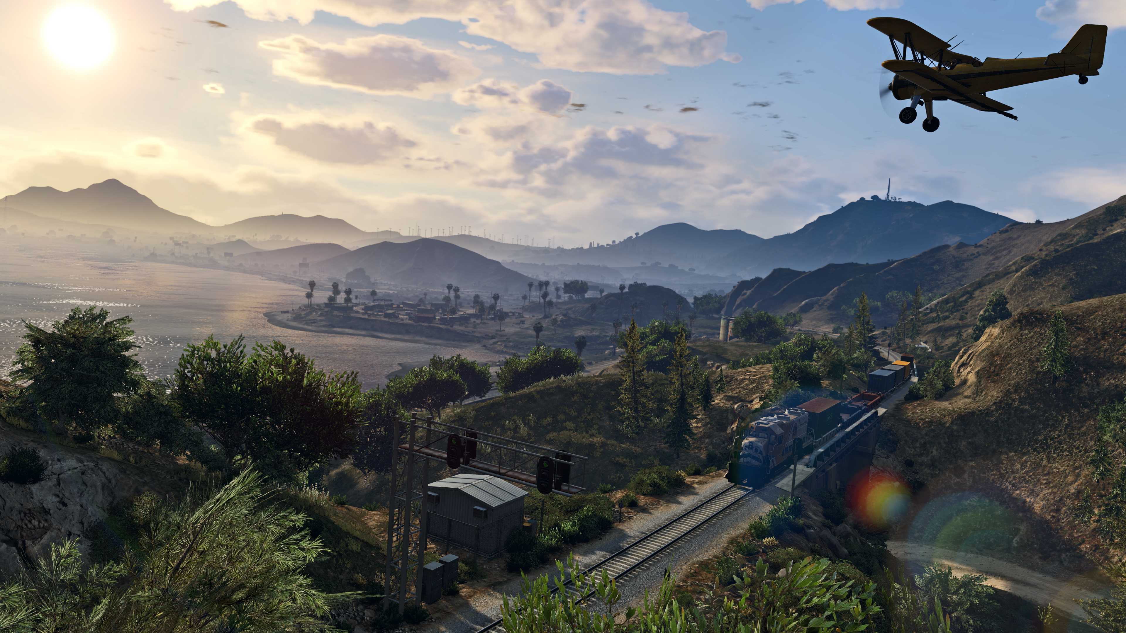 Screenshot from video game Grand Theft Auto V of biplane flying over tropical coastline