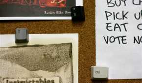 keycap thumbtacks on corkboard