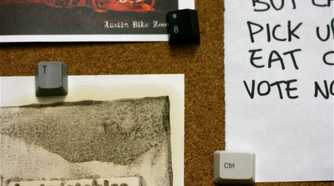 keycap thumbtacks on corkboard