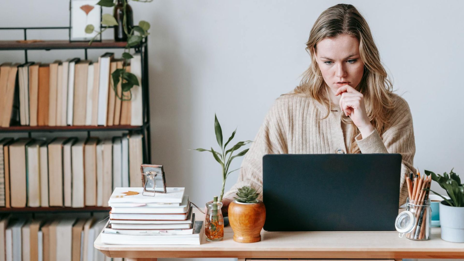 Pensive woman looking at her laptop screen.