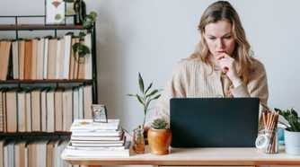 Pensive woman looking at her laptop screen.