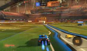 Screenshot from Rocket League video game of car driving towards large ball in arena