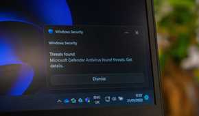A Windows Security notification showing the Microsoft Defender Antivirus catching threats.