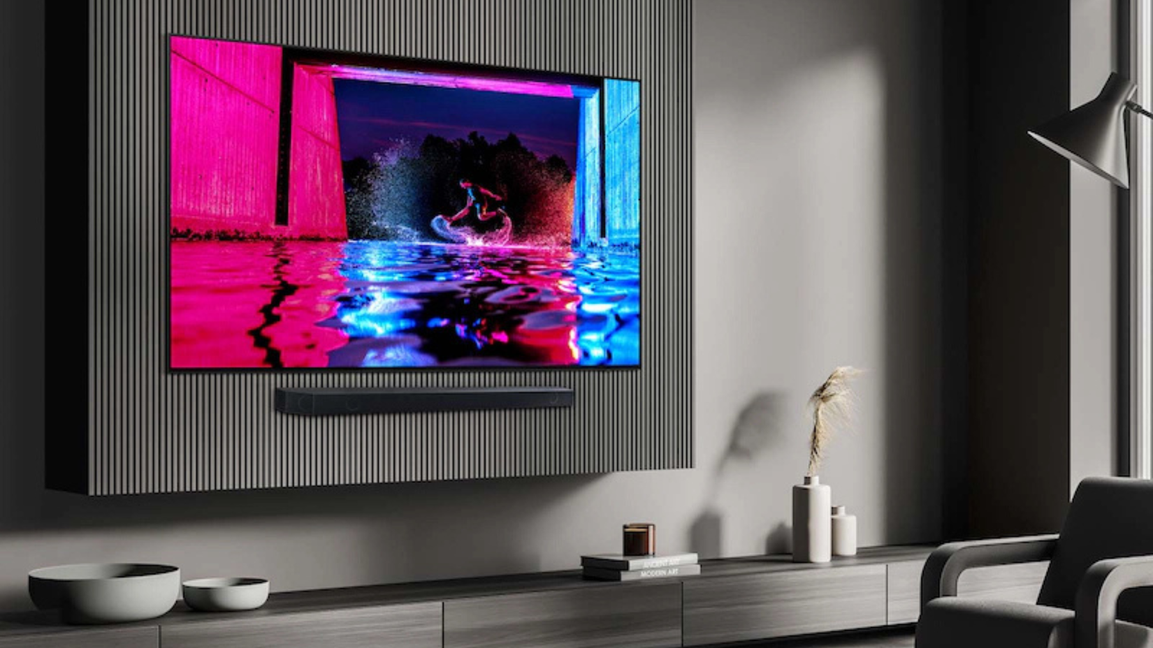 A wall-mounted frameless TV with dull gray surroundings.