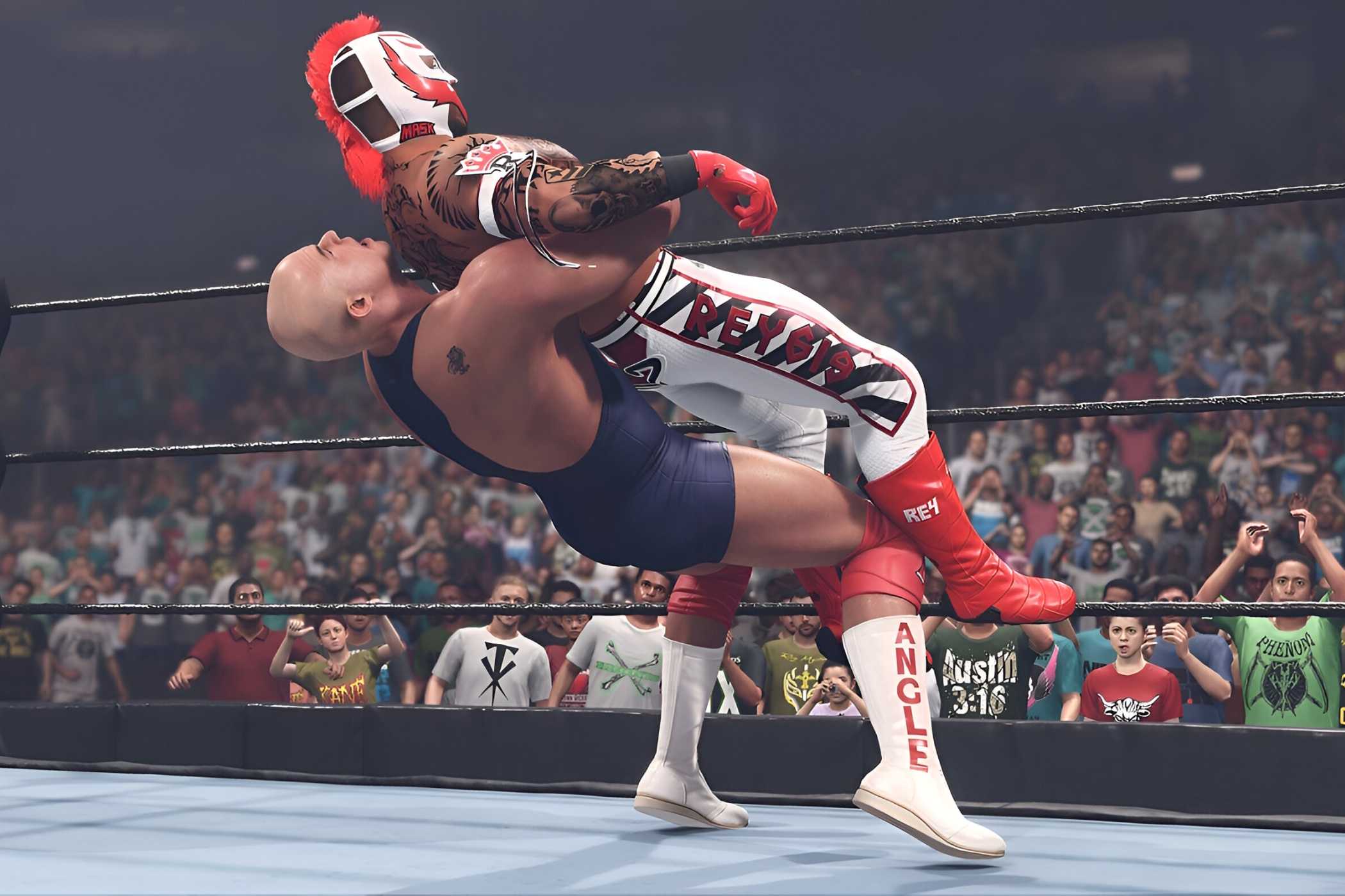 A screenshot from WWE 2K23, showing Kurt Angle, the bald wrestler, hit Rey Mysterio in the white tights, with a German Suplex.
