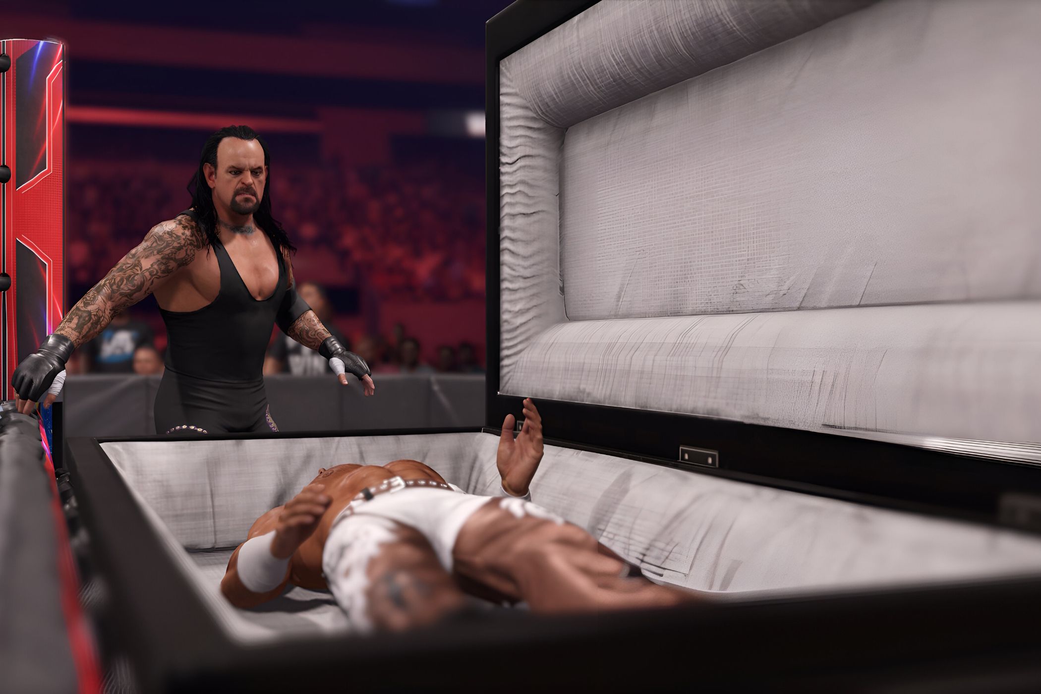 A screenshot from WWE 2K24, showing the Undertaker, wearing a black vest and tights, look over Shawn Michaels who is laying inside a white-lined casket.