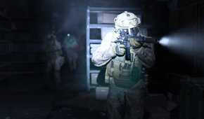 Screenshot from Call of Duty: Modern Warfare (2019) video game of armed soldiers walking through a dark room with flashlights