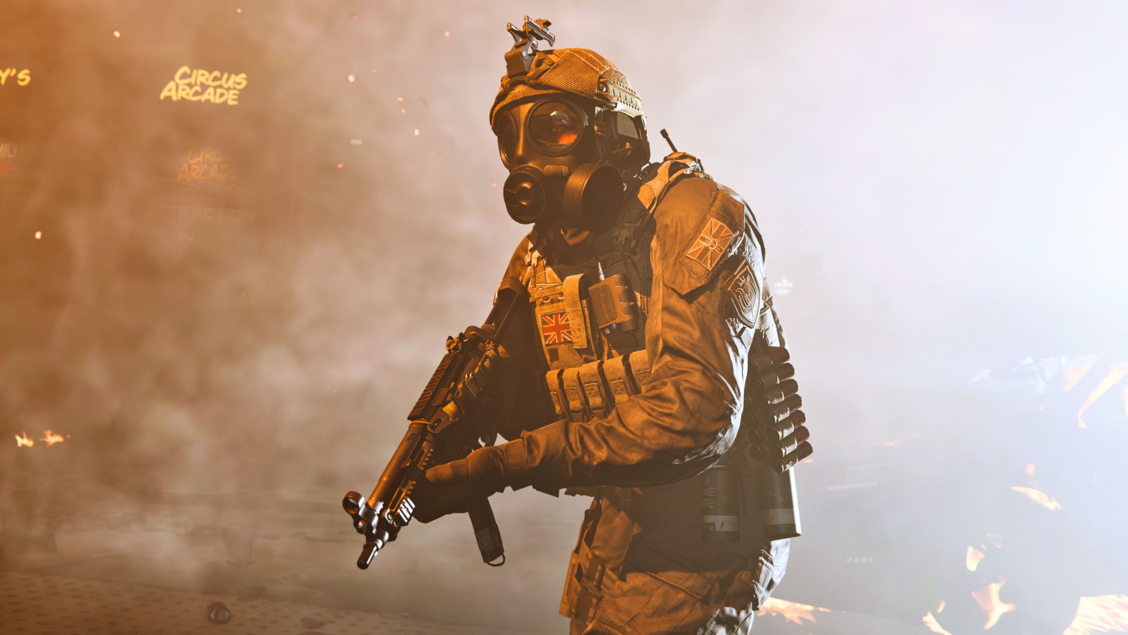 Screenshot from Call of Duty: Modern Warfare (2019) video game of armed soldier with gas mask on lit by flares