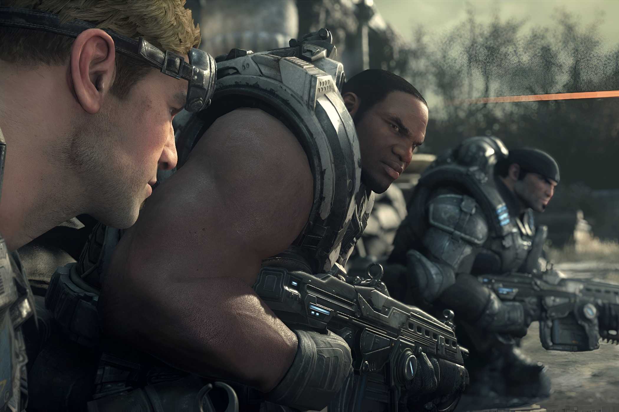 A screenshot from the game Gears of War: Ultimate Edition, showing three men wearing armor and weilding weapons.