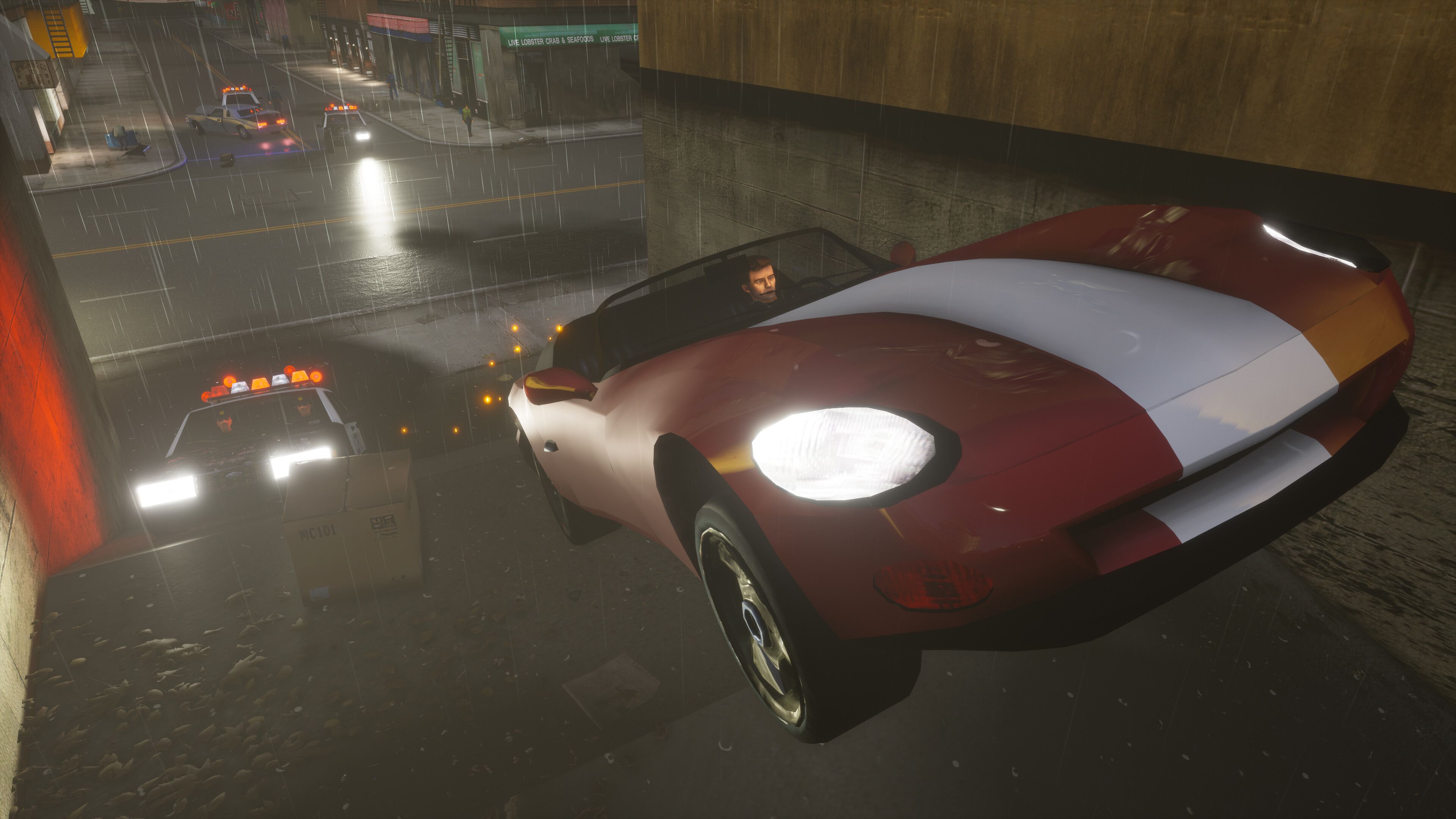 Screenshot from Grand Theft Auto Trilogy: The Definitive Edition video game of car flying through the air on a rainy night in Grand Theft Auto III