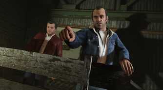 Trevor pointing at the direction of the screen and Michael standing behind him
