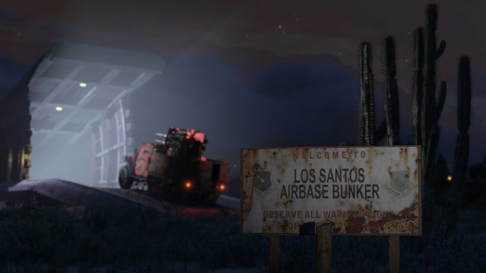 Military-grade vehicle entering an opened bunker with a rusty sign in the foreground reading: "Welcome to Los Santos Airbase Bunker" and the rest is illegible