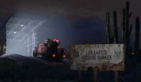 Military-grade vehicle entering an opened bunker with a rusty sign in the foreground reading: "Welcome to Los Santos Airbase Bunker" and the rest is illegible