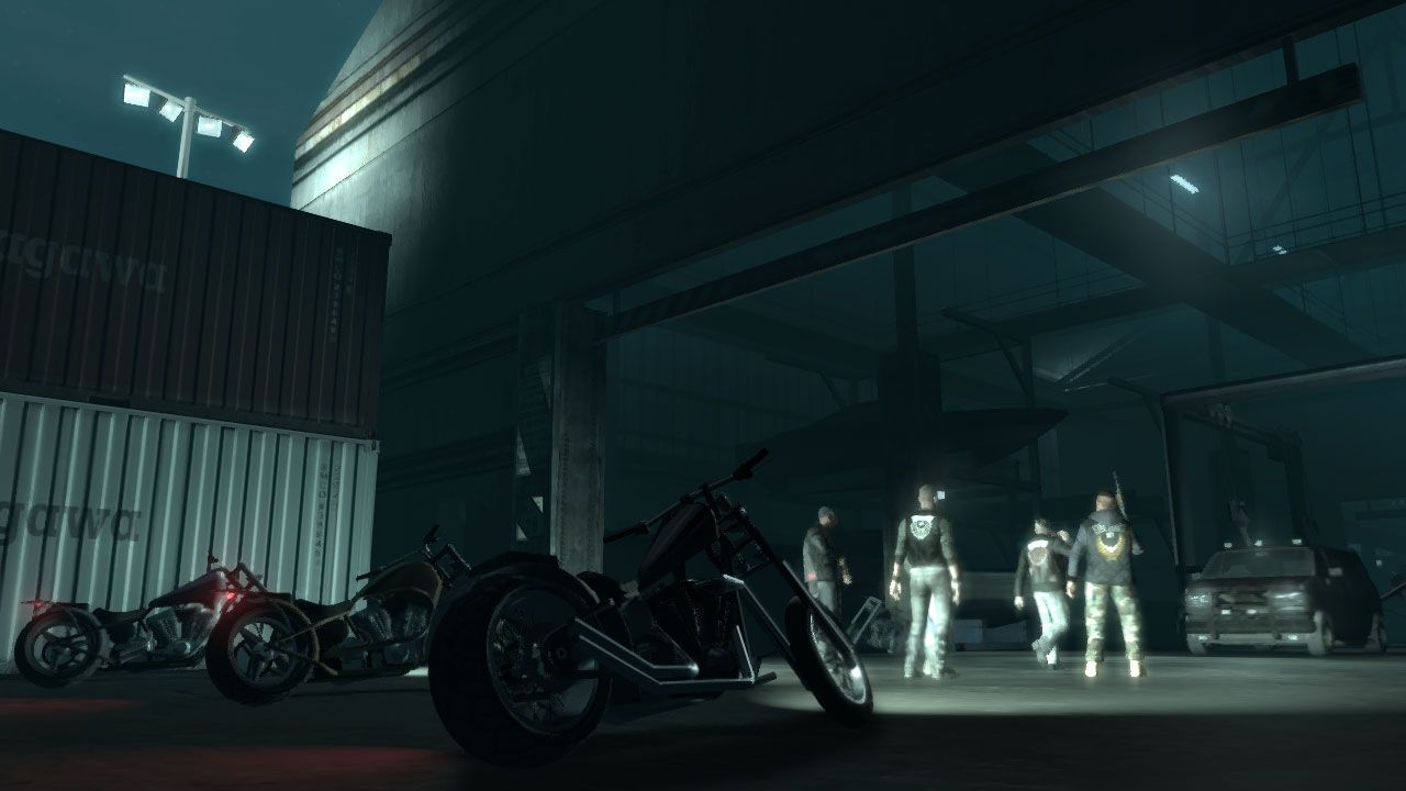 Three parked bikes at night in front of a storage facility where a biker gang meeting is taking place
