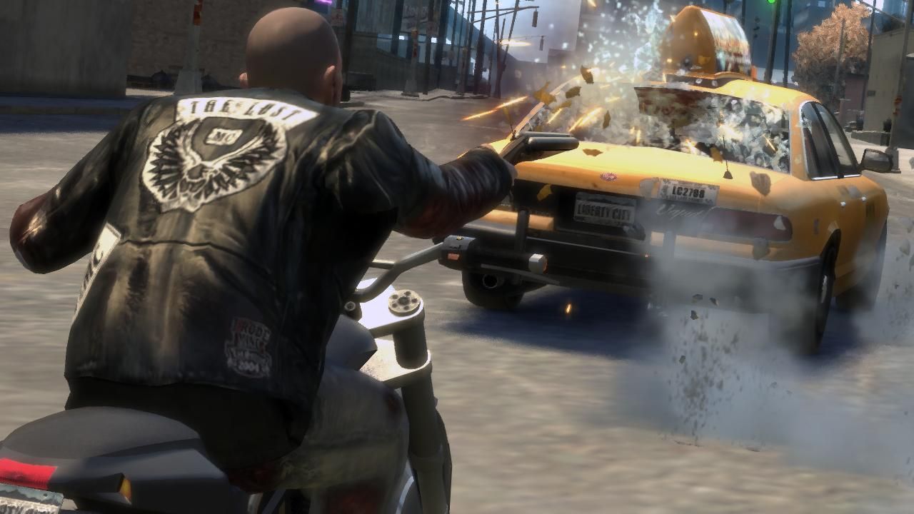Johnny, ridden on his bike, shooting his shotgun at the rear of a taxi