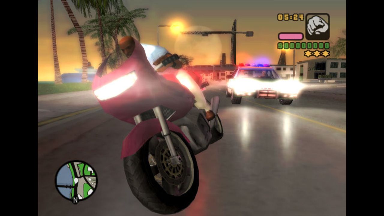 Police car in the background chasing Vic on a motorbike
