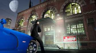 GTA Online character sitting on car in front of foreclosed building
