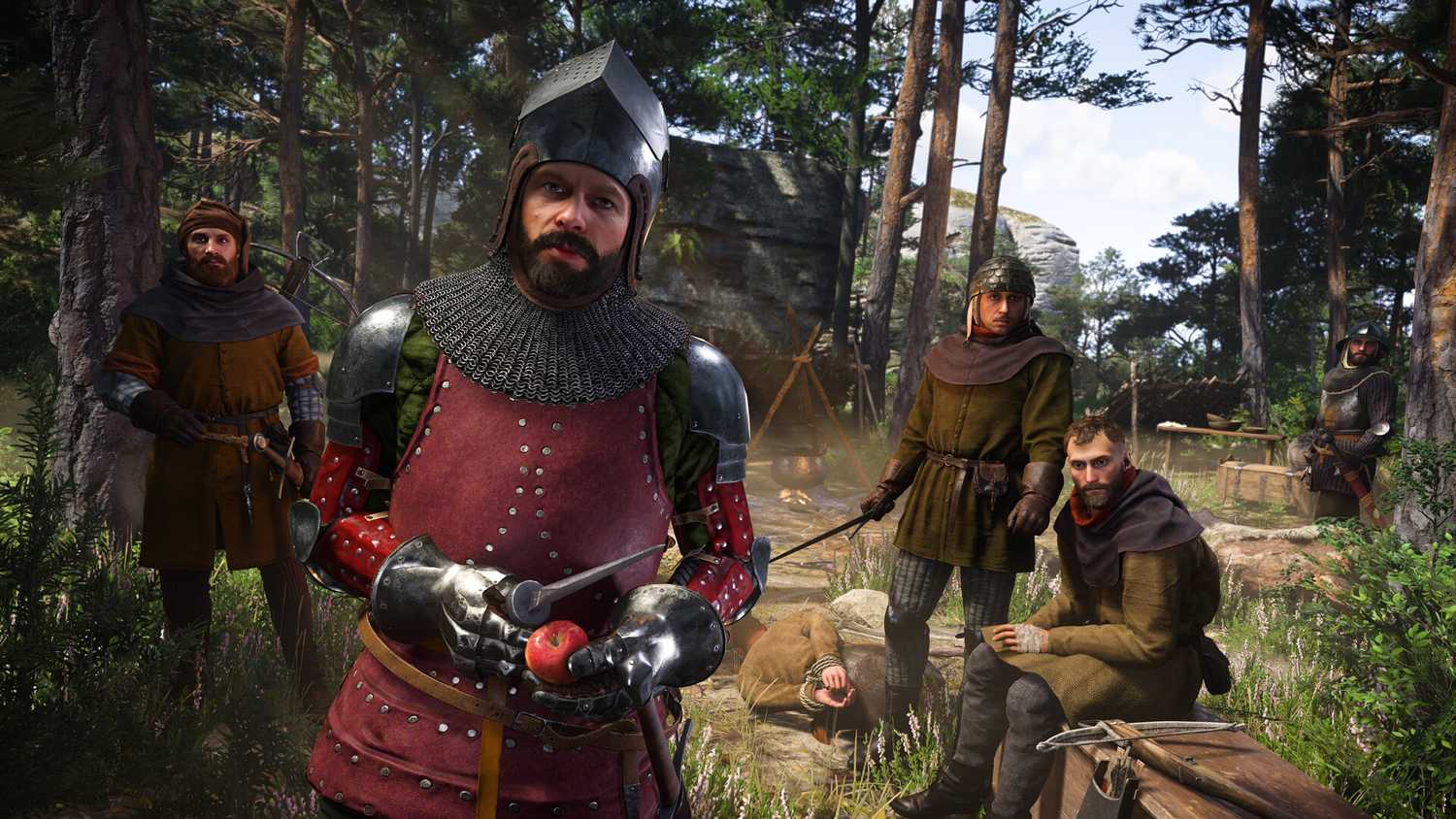 six men at a camp in the woods in medieval setting, one dressed in heavy armor.