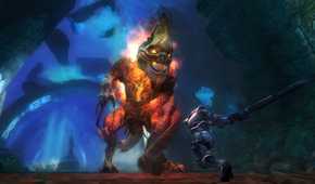 Screenshot from Kingdoms of Amalur: Reckoning video game of character fighting giant masked fire monster