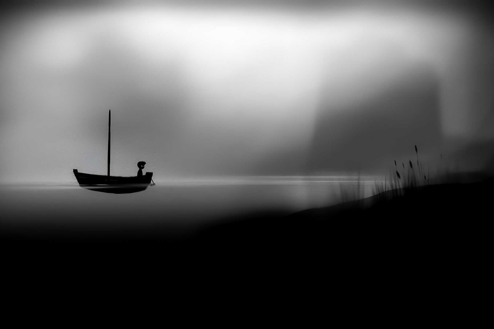 A screenshot from the game Limbo, where the silhouetted protagonist travels in a boat on water.