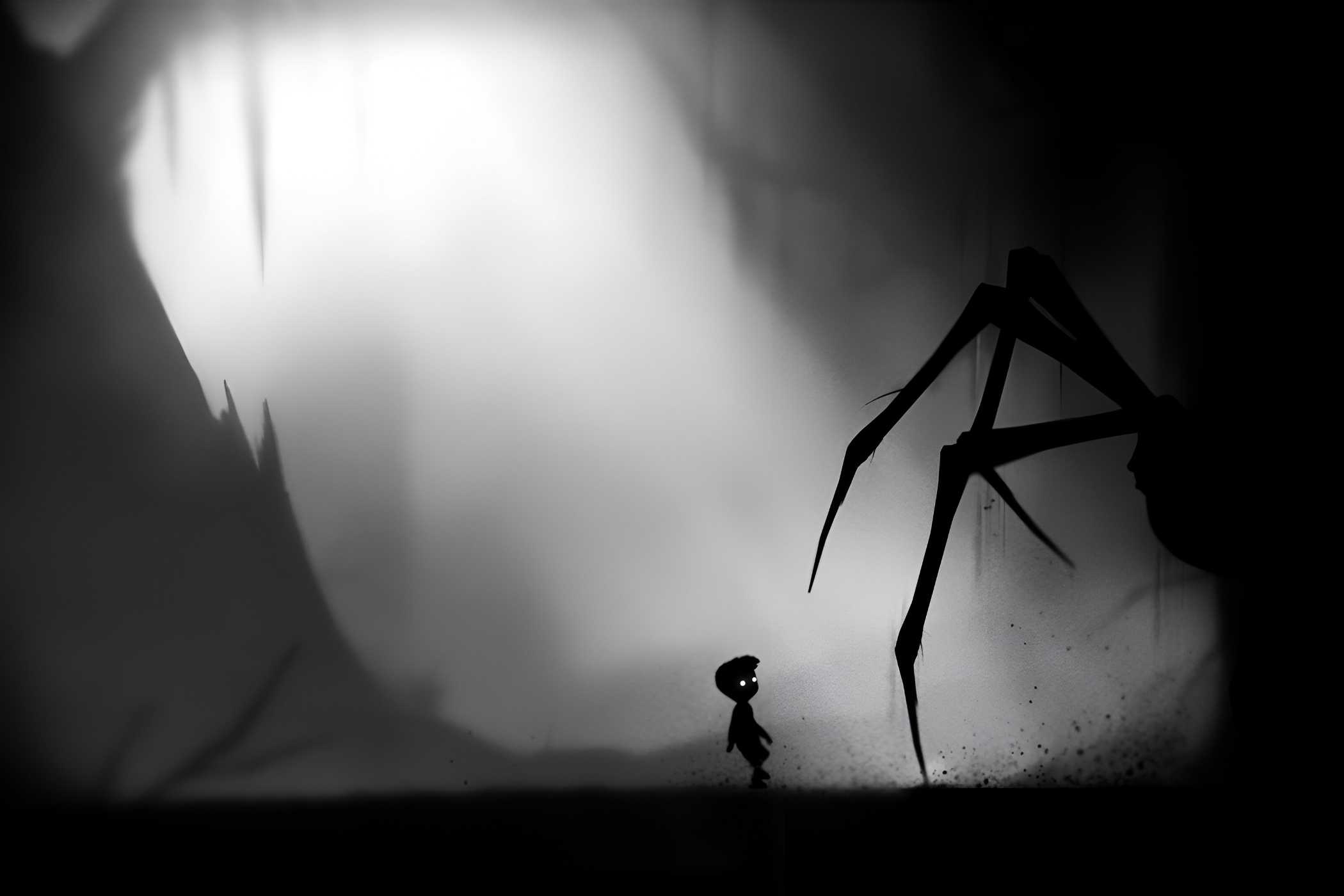 A screenshot from the game Limbo, showing a monochromatic art style while the protagonist faces down a huge spider.