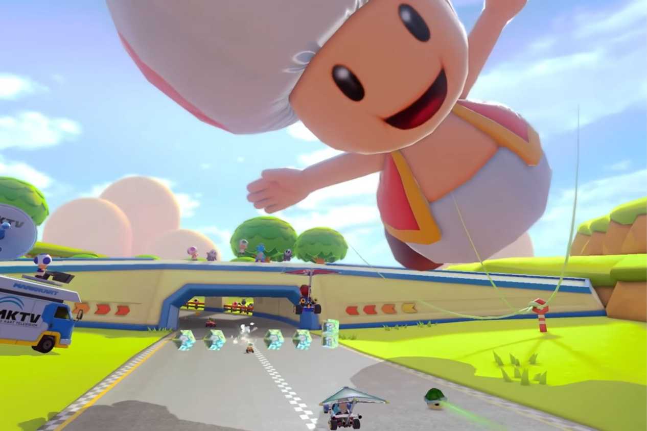 Mario Kart 8 players driving under giant toad balloon