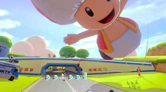 Mario Kart 8 players driving under giant toad balloon