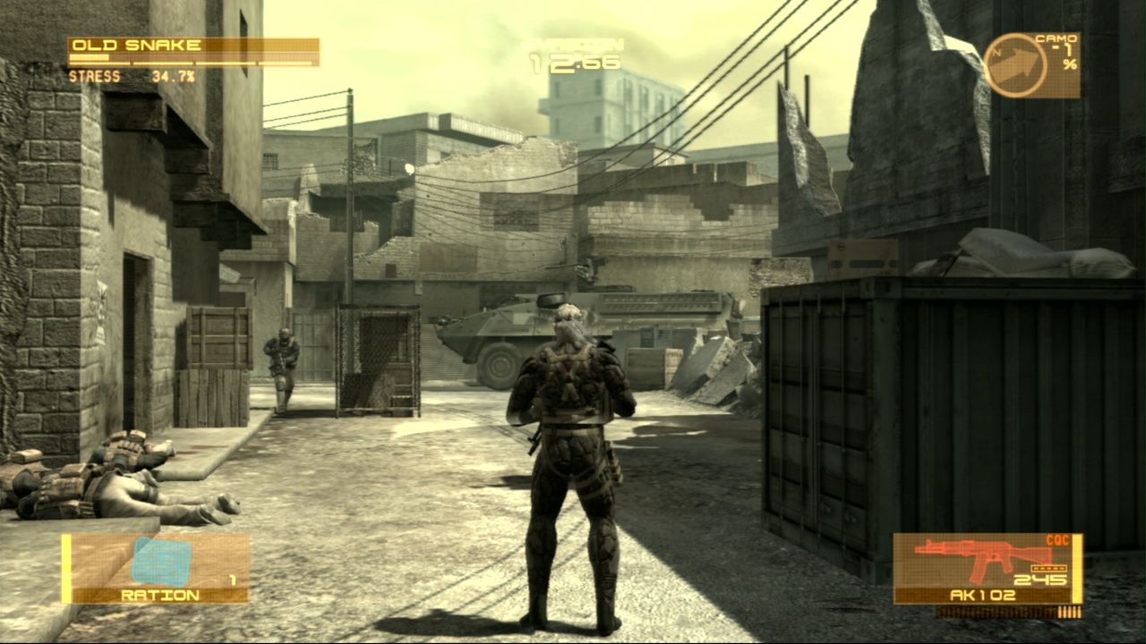 Sceenshot from Metal Gear Solid 4: Guns of the Patriots video game of player character standing in war-torn street with a tank on the road and an armed man to the left.