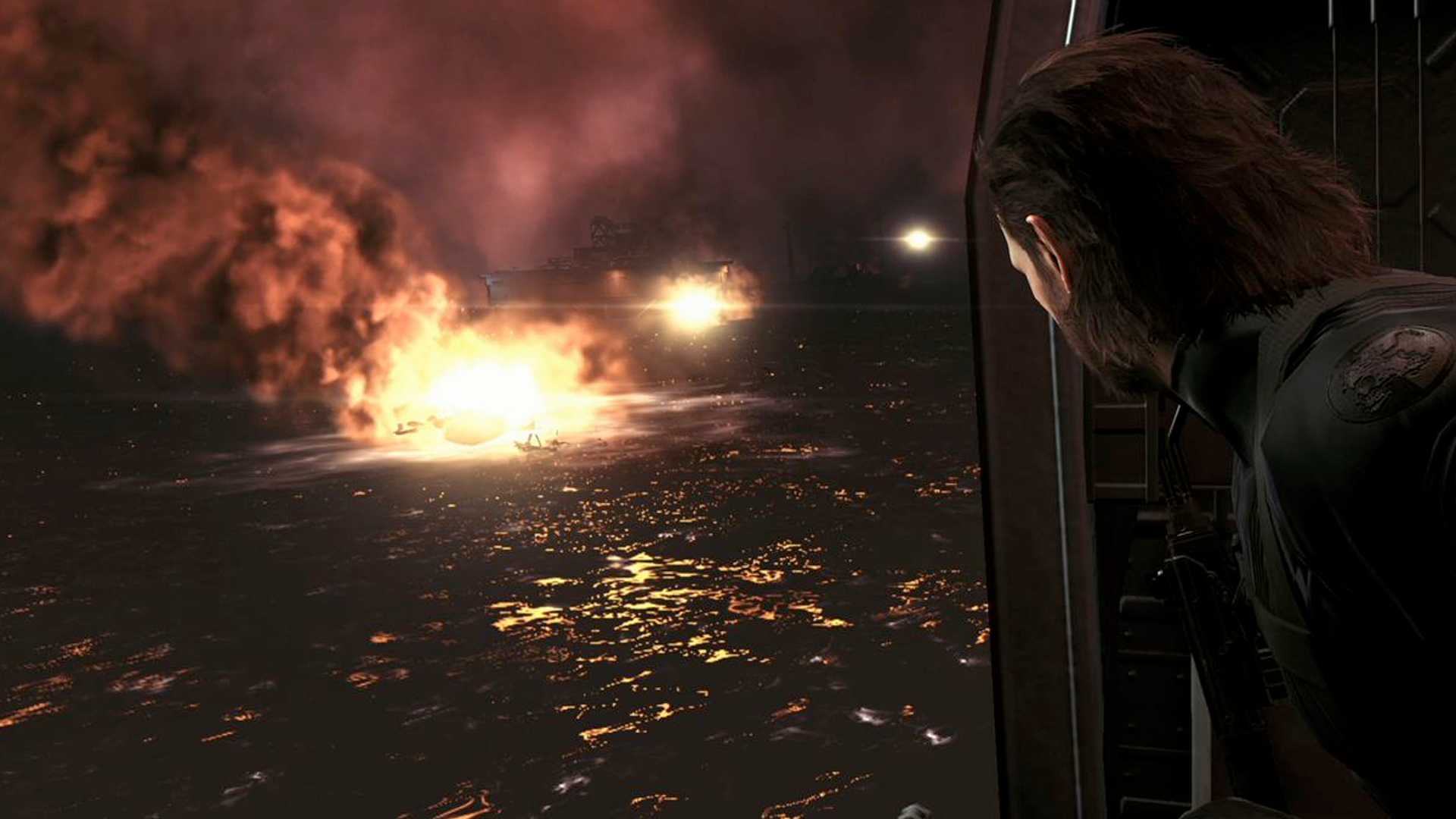MGSV Ground Zeroes screenshot, Snake looks out of the helicopter at the destruction of Mother Base