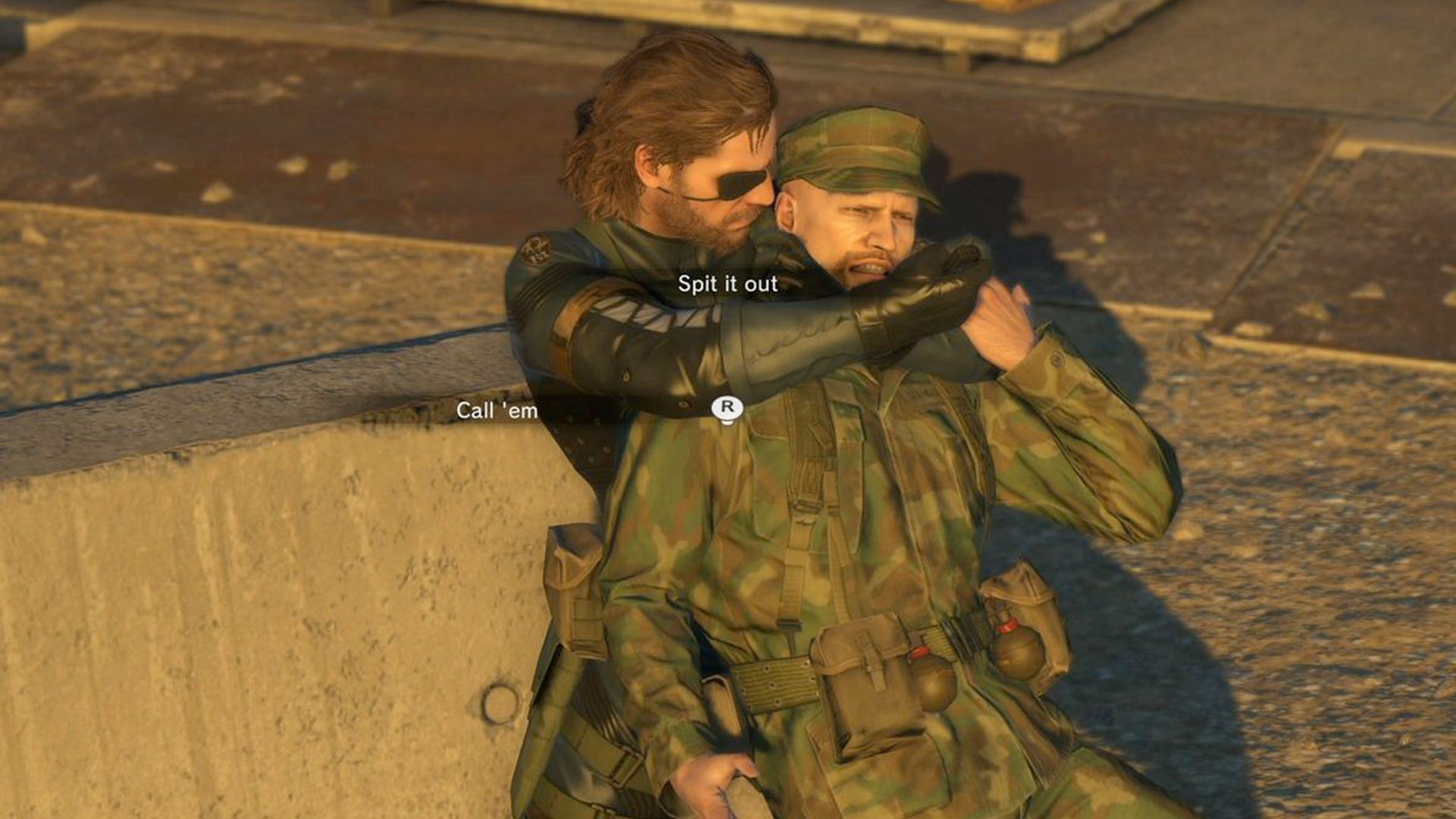 MGSV Ground Zeroes screenshot, Snake holds someone hostage as a UI is overlaid saying "Spit it out" and "Call 'em" 