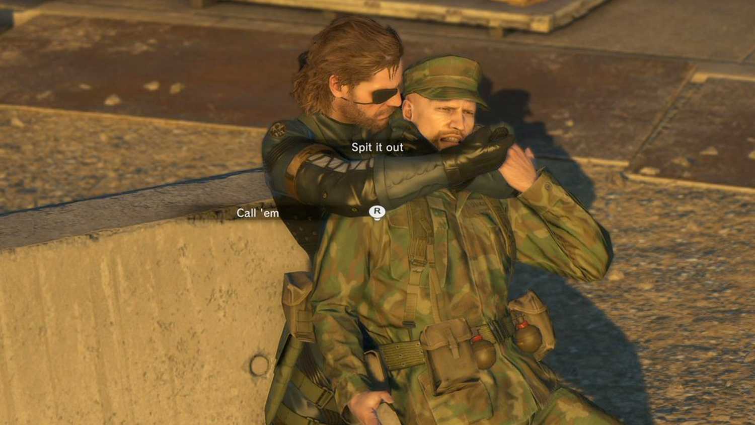 MGSV Ground Zeroes screenshot, Snake holds someone hostage as a UI is overlaid saying "Spit it out" and "Call 'em"