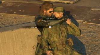 MGSV Ground Zeroes screenshot, Snake holds someone hostage as a UI is overlaid saying "Spit it out" and "Call 'em"