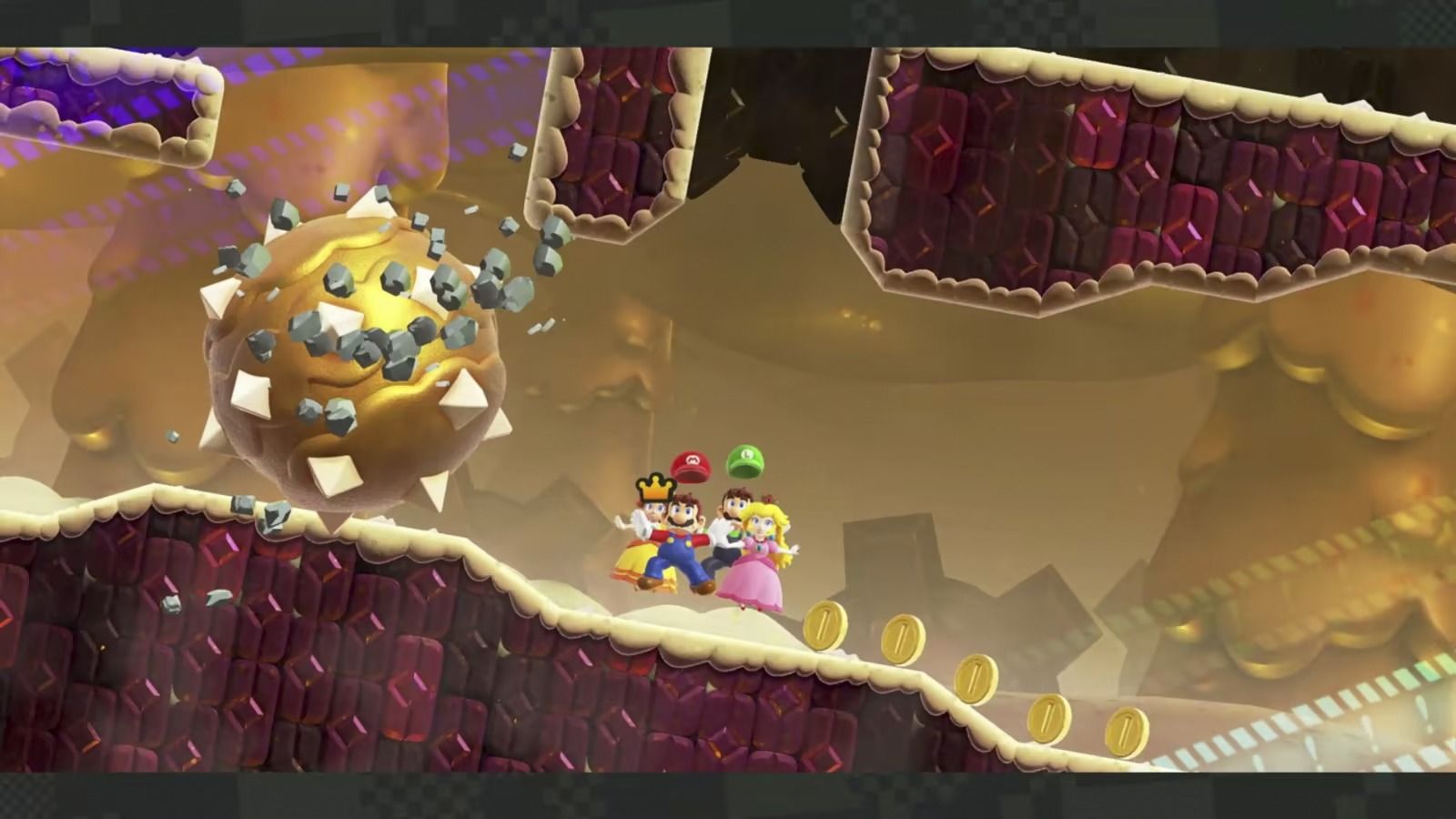 Screenshot of Mario, Luigi, Princess, and Daisy escaping spiked bolder Mario Wonder