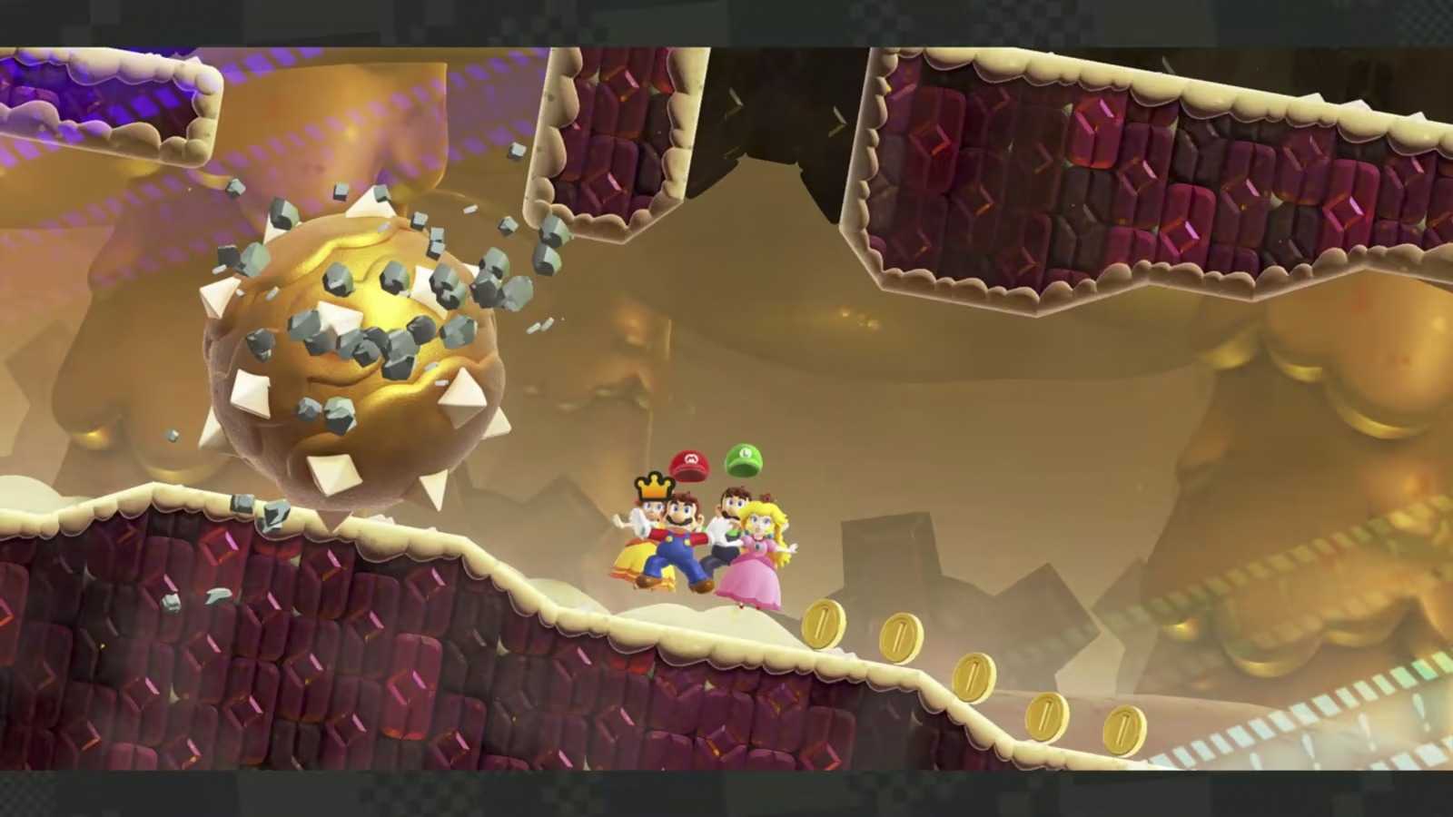 Screenshot of Mario, Luigi, Princess, and Daisy escaping spiked bolder Mario Wonder