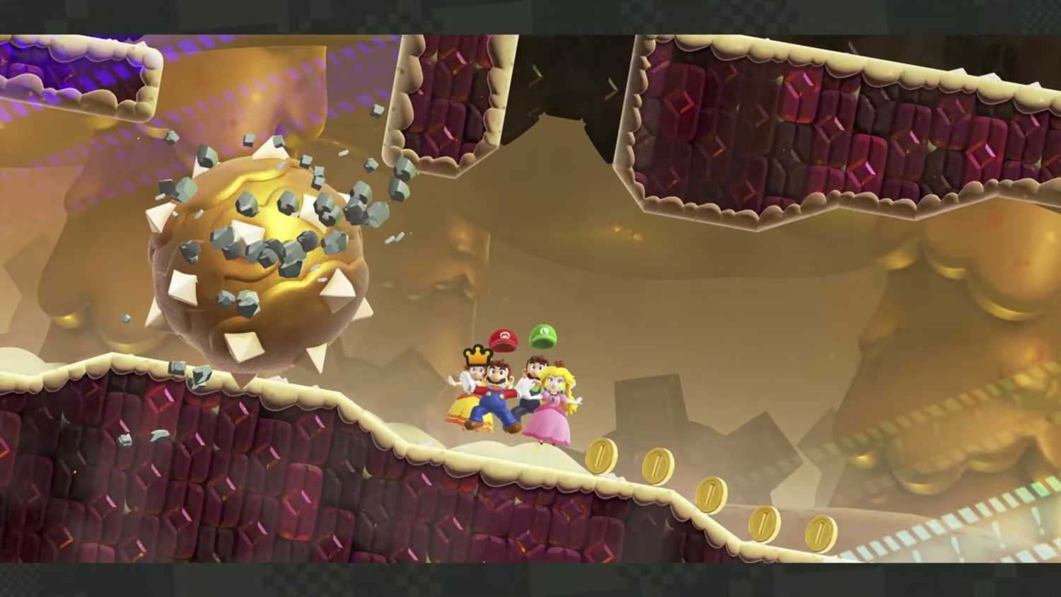Screenshot of Mario, Luigi, Princess, and Daisy escaping spiked bolder Mario Wonder