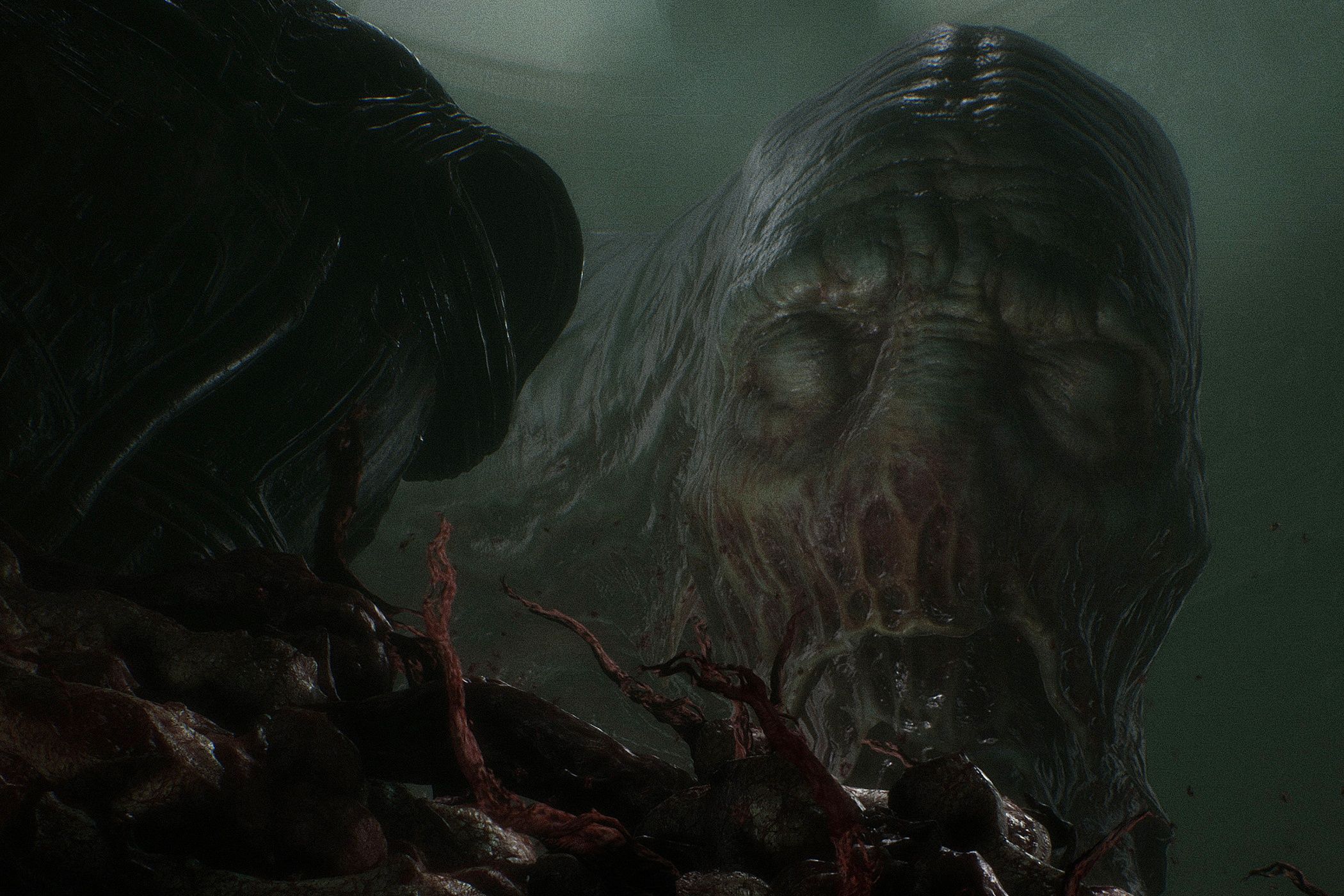 A screenshot from the game Scorn, showing a grotesque, huge biomechanical face looming in the darkness with its eyes closed.