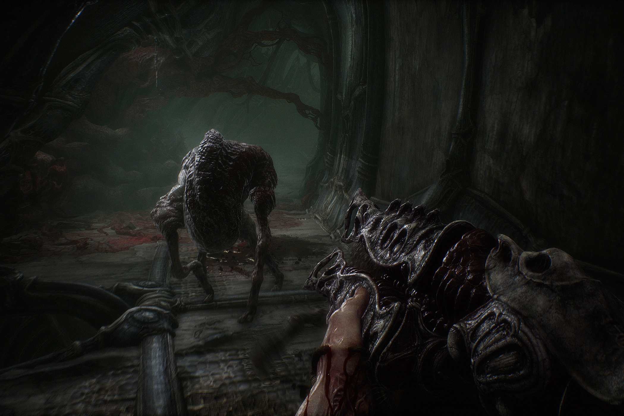 A screenshot from the game Scorn, showcasing the game's gameplay elements, with a gun and a hostile combatant running at the camera on its legs.