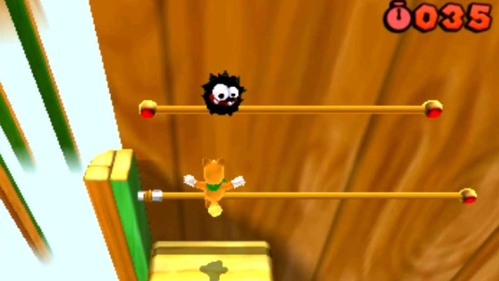 Screenshot of Tanooki Mario and a Fuzzy from Super Mario Bros. 3D Land