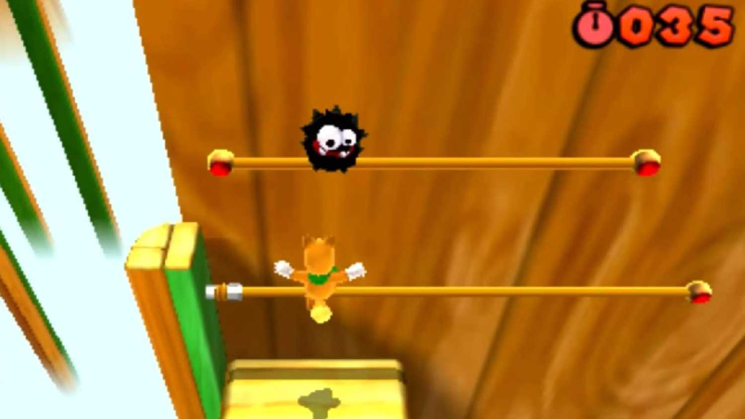 Screenshot of Tanooki Mario and a Fuzzy from Super Mario Bros. 3D Land