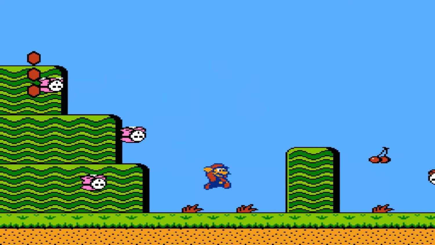 Screen shot from Super Mario Bros. 2 of Mario taking out Shy Guys