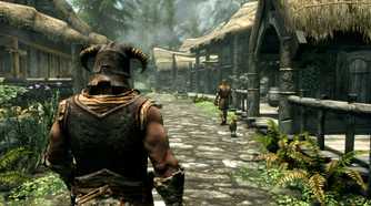 A screenshot from the game The Elder Scrolls V: Skyrim, showing a muscular man with a horned helmet walking down a lush village street.