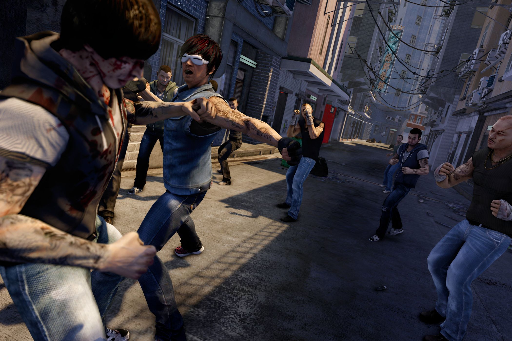 A screenshot from the game Sleeping Dogs, showing multiple characters engage ina street fight in an alley in Hong Kong.