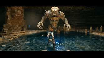 Screenshot from Star Wars: Jedi Survivor video game of main character Kal Cestis fighting Rancor monster in underground pit