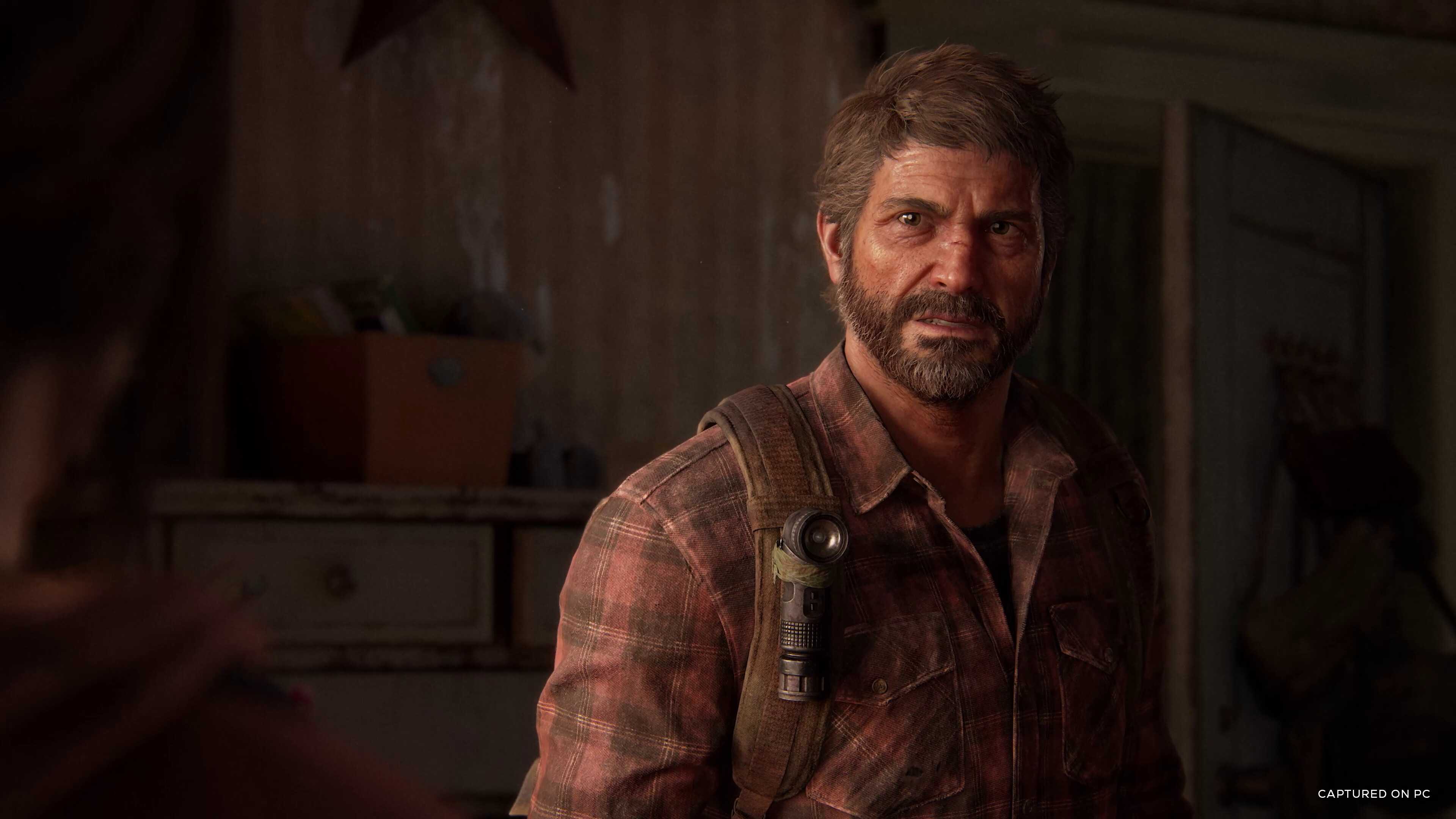 Screenshot from The Last Of Us Part I video game on PC of main character Joel in dilapidated bedroom