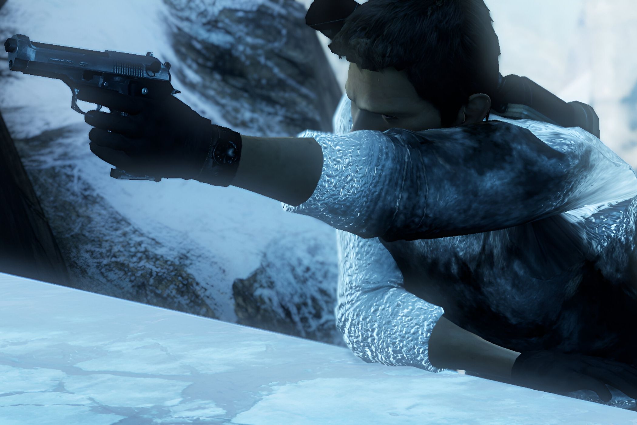 A screenshot from the game Uncharted 2, showing a man brandishing a gun while climbing a snowy ledge.