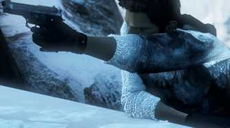 A screenshot from the game Uncharted 2, showing a man brandishing a gun while climbing a snowy ledge.