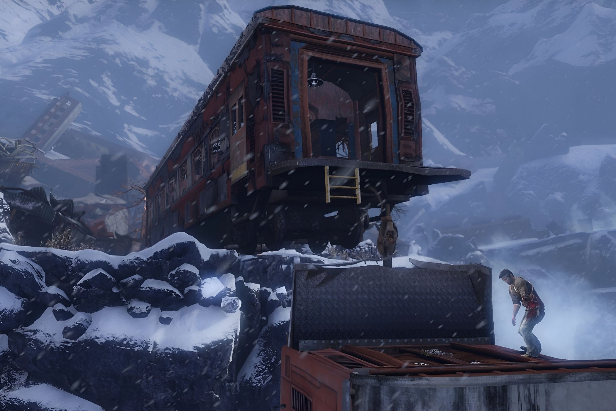 A screenshot from the game Uncharted 2: Among Thieves, showing a derailed train in a snowy mountain with the protagonist standing underneath it. 