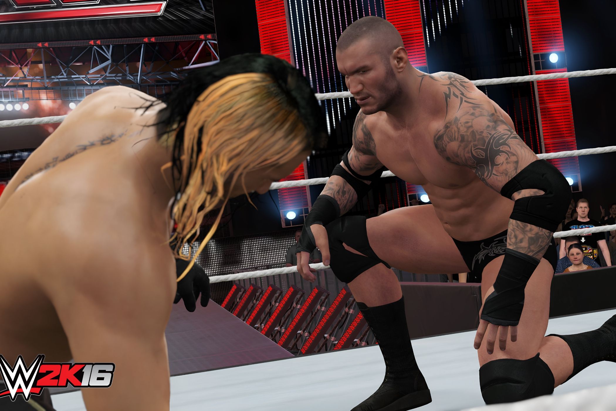 A screenshot from WWE 2K16, showing a bald Randy Orton lean across the ring from Seth Rollins, sporting blonde and black hair.