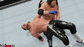 A screenshot from WWE 2K17, showing superstar AJ Styles hit a backbreaker on Dolph Ziggler.